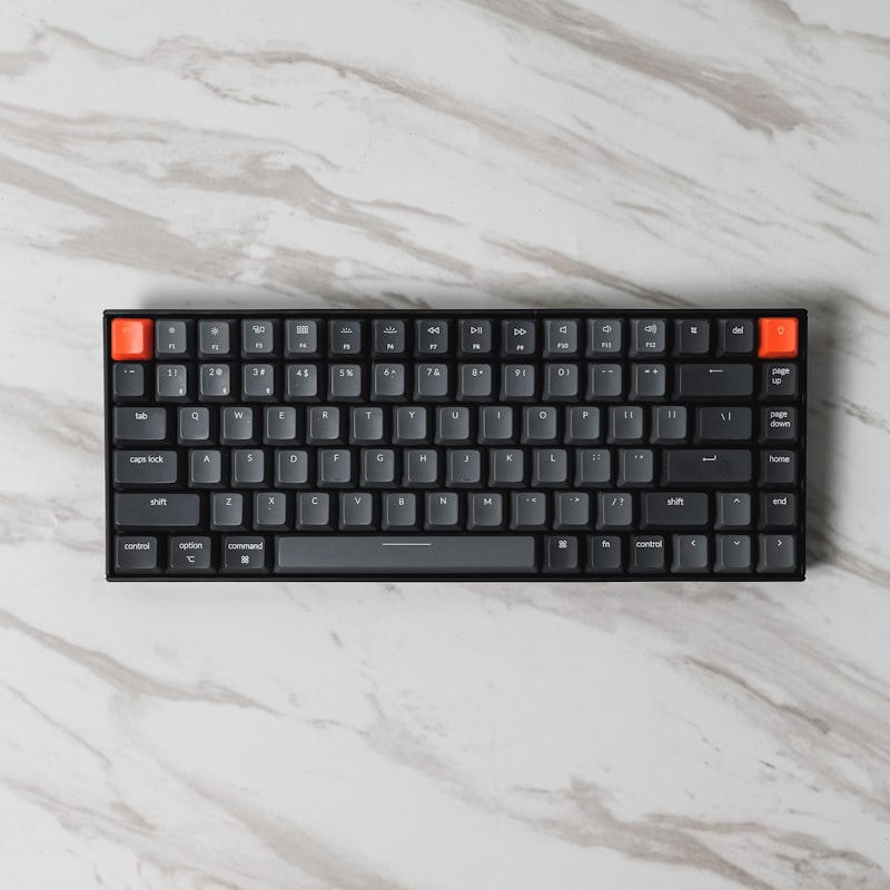 Teclado mecânico customizado e mouse sem fio em uma mesa limpa